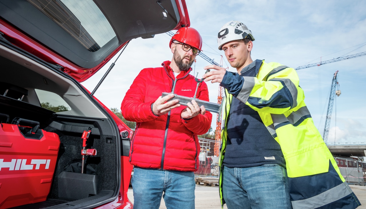 Hilti pracovník so zákazníkom pri aute